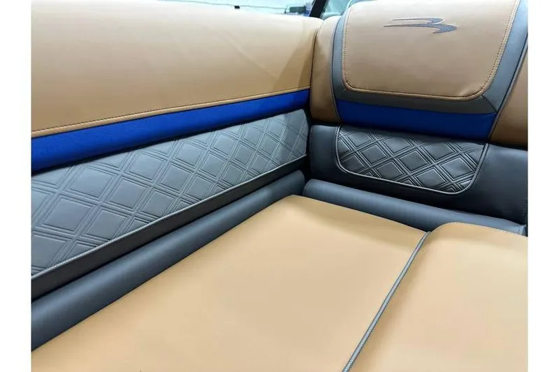 Slide: The Image of Luxurious interior of 2026 Bennington 22 SSB Swingback with tan and blue accents. - 9