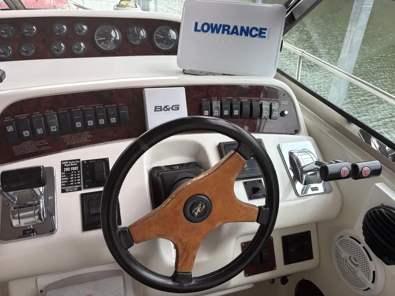 Slide: The Image of 1995 Sea Ray Sundancer 370 helm with wood steering wheel. - 14