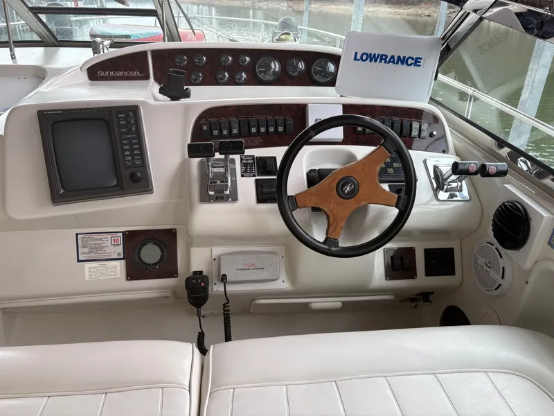 Slide: The Image of 1995 Sea Ray Sundancer 370 cockpit with steering wheel and instruments. - 8