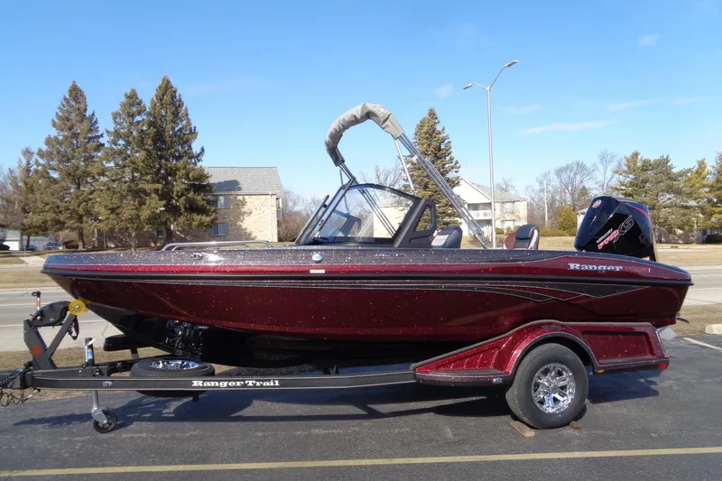 The Image of 2026 Ranger 1850MS Reata boat on trailer, parked outdoors, under clear blue sky. - 1