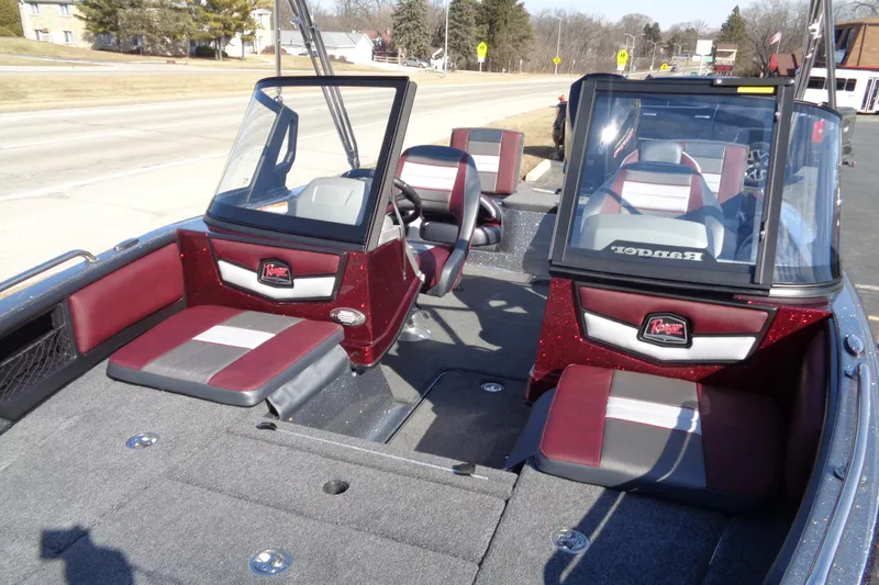 Slide: The Image of 2026 Ranger 1850MS Reata boat interior with red and gray seating, dual consoles. - 20