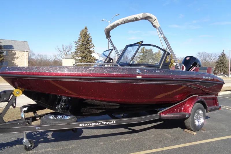Slide: The Image of 2026 Ranger 1850MS Reata boat on trailer, sparkling red finish, parked outdoors. - 21