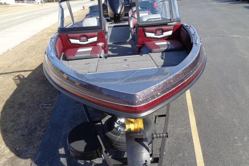 Slide: The Image of 2026 Ranger 1850MS Reata boat with red and gray interior on a trailer. - 9