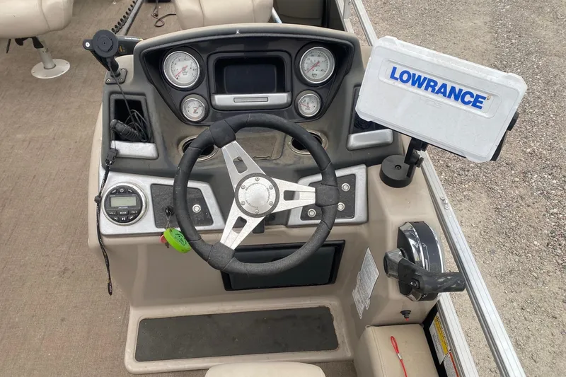 Slide: The Image of 2024 Ranger Reata 220F boat dashboard with steering wheel and Lowrance navigation system. - 11