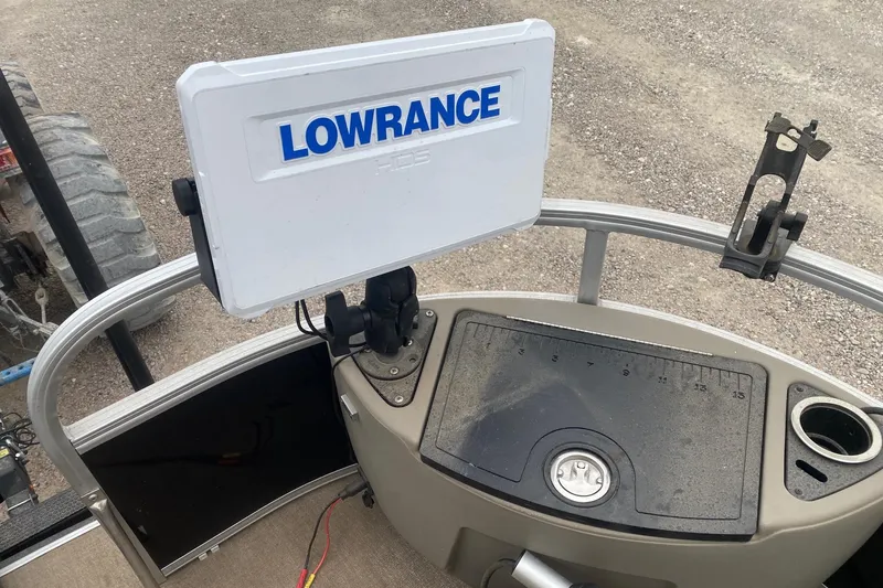 Slide: The Image of 2024 Ranger Reata 220F boat console with Lowrance HDS display and fishing tool holder. - 12