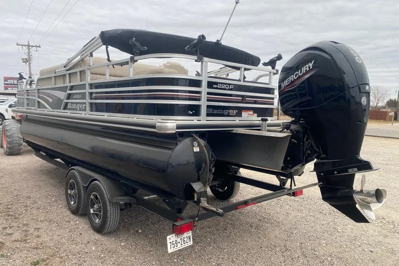 Slide: The Image of 2024 Ranger Reata 220F pontoon boat with Mercury outboard motor on trailer. - 4