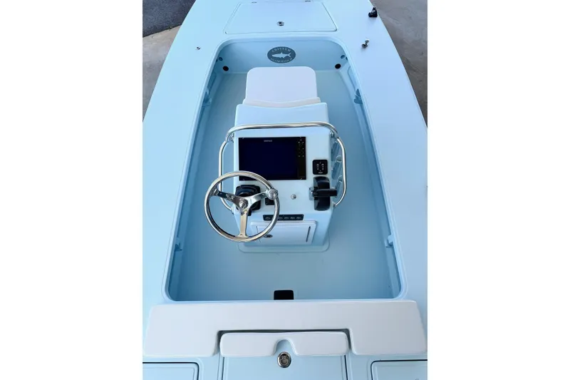 Slide: The Image of 2026 Chittum Skiffs 18 Islamorada boat interior with steering wheel and control panel. - 14