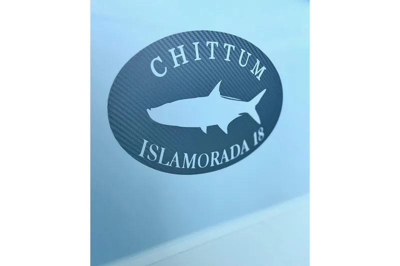 Slide: The Image of Chittum Skiffs 18 Islamorada 2026 logo with shark silhouette on blue background. - 2