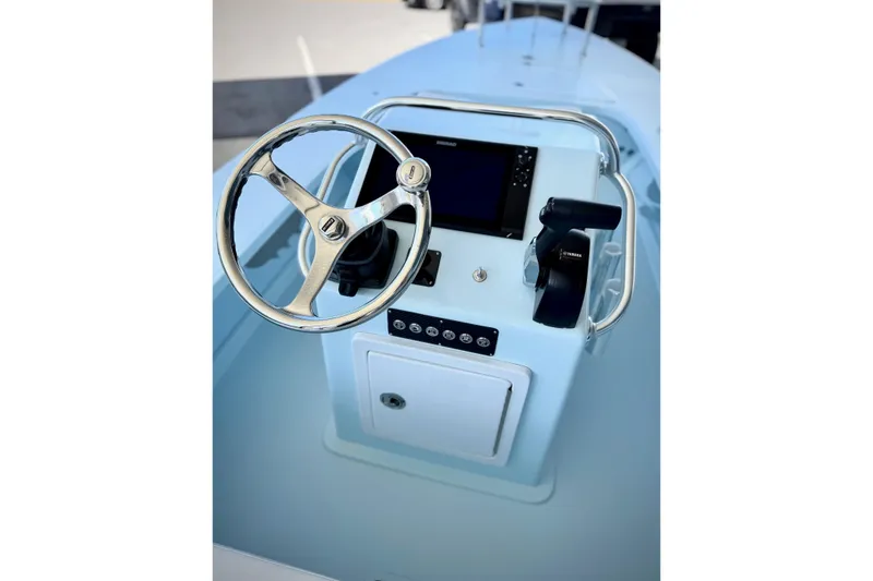 Slide: The Image of 2026 Chittum Skiffs 18 Islamorada boat console with steering wheel and controls. - 3