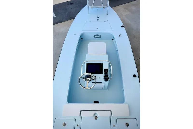 Slide: The Image of 2026 Chittum Skiffs 18 Islamorada boat interior with steering console and seating. - 4