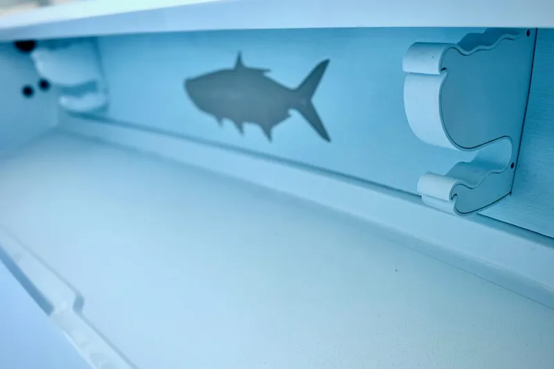 Slide: The Image of Interior detail of 2026 Chittum Skiffs 18 Islamorada, featuring fish silhouette design. - 5