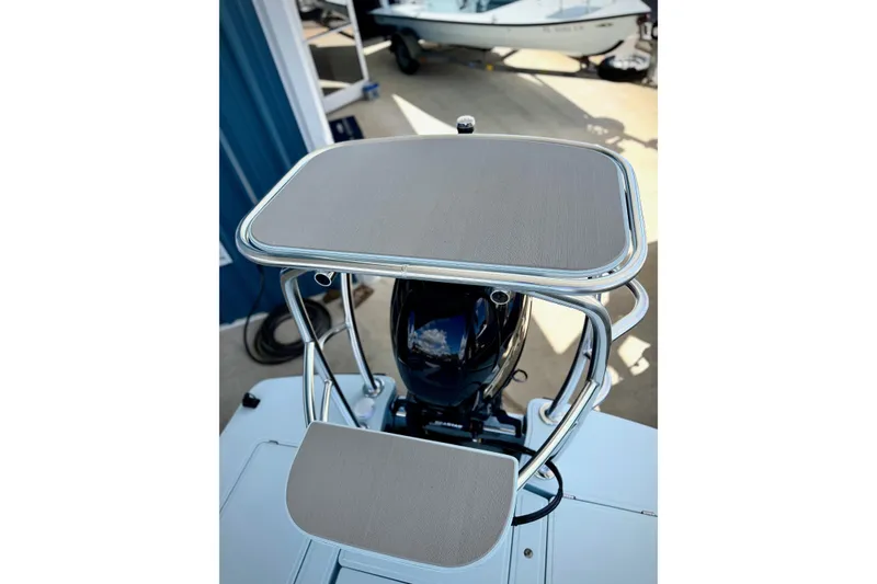 Slide: The Image of 2026 Chittum Skiffs 18 Islamorada boat with sleek console and polished metal frame. - 7
