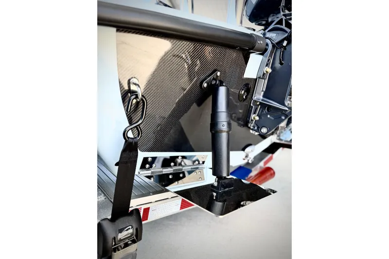 Slide: The Image of 2026 Chittum Skiffs 18 Islamorada boat transom with carbon fiber detailing and secure strap. - 8