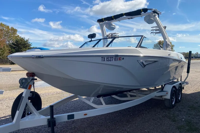 Slide: The Image of 2024 Tigé Z3 boat on trailer under clear blue sky. - 3