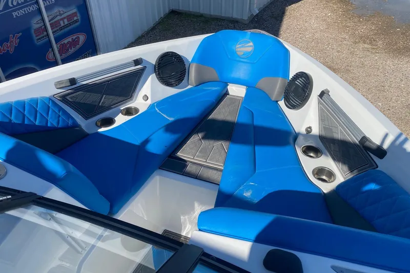 Slide: The Image of 2024 Tigé Z3 boat interior with blue seating and cup holders. - 8
