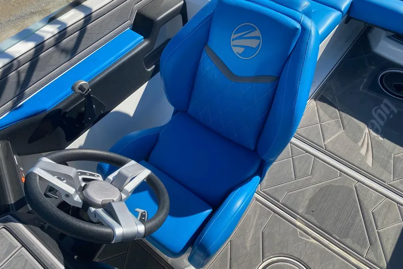 Slide: The Image of 2024 Tigé Z3 boat interior with blue captain's seat and modern steering wheel. - 9