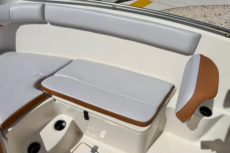 Slide: The Image of 2021 Sailfish 242 CC boat seating area with white and brown cushions. - 11
