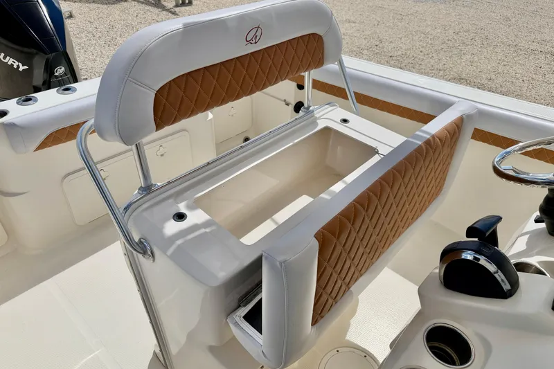 Slide: The Image of 2021 Sailfish 242 CC boat interior with tan diamond-stitched seating and steering wheel. - 15