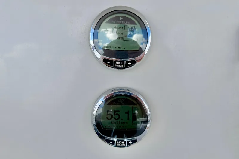 Slide: The Image of Boat dashboard gauges displaying fuel and battery levels on a 2021 Sailfish 242 CC. - 20