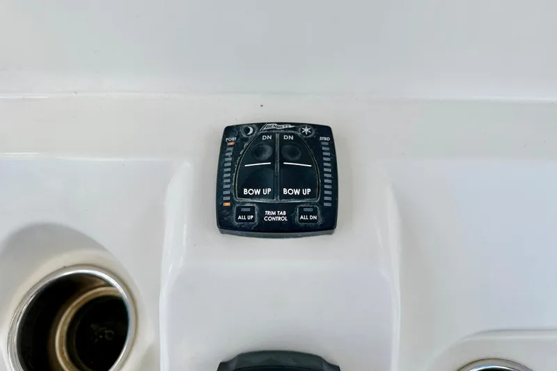 Slide: The Image of Control panel on 2021 Sailfish 242 CC boat, featuring trim tab controls. - 21