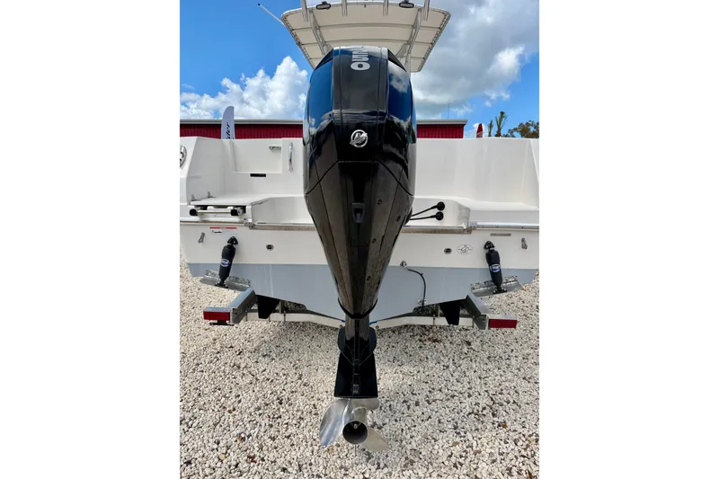 Slide: The Image of 2021 Sailfish 242 CC boat with outboard motor on gravel surface. - 29