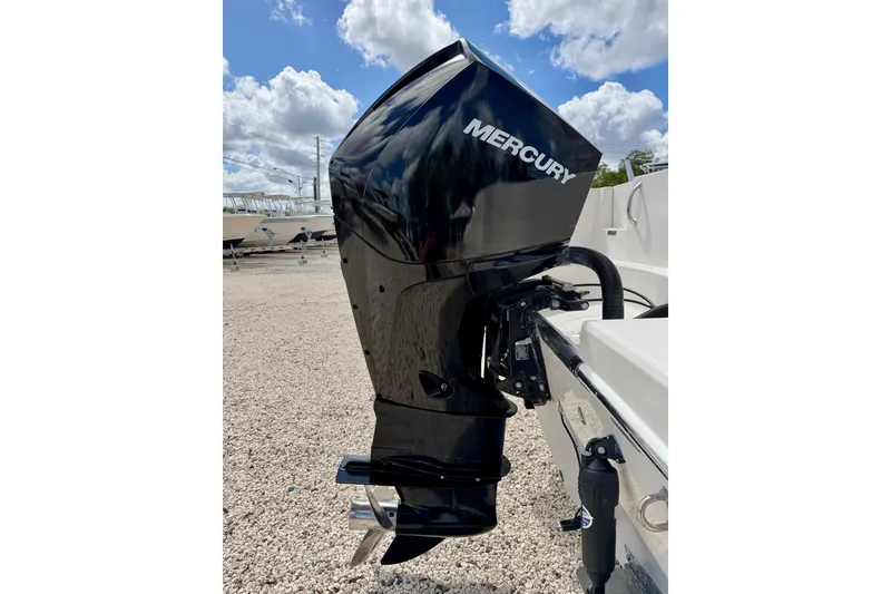 Slide: The Image of 2021 Sailfish 242 CC with Mercury outboard motor under a bright blue sky. - 30