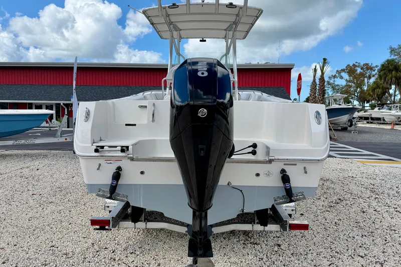Slide: The Image of 2021 Sailfish 242 CC boat with outboard motor, parked on gravel lot. - 6