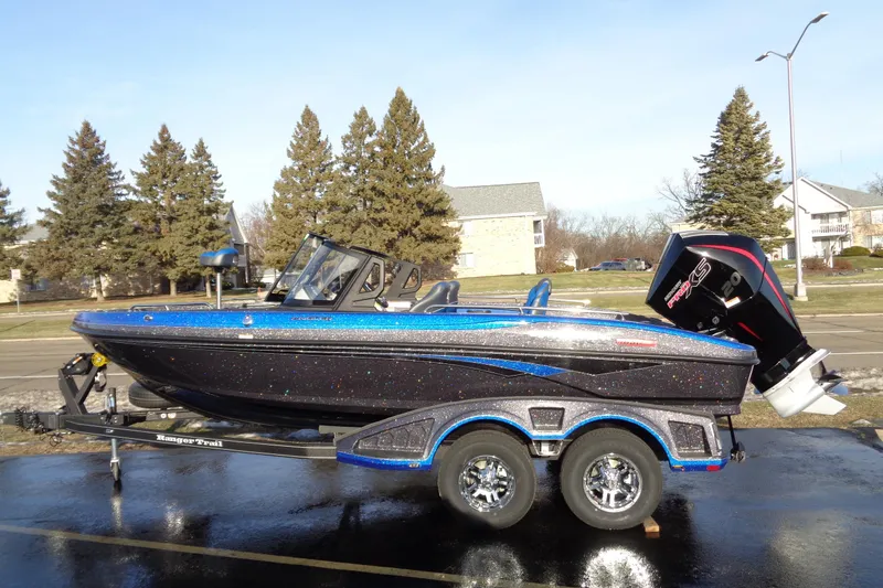 The Image of 2026 Ranger 1880MS Angler boat on trailer, parked outdoors, with trees and houses in background. - 1