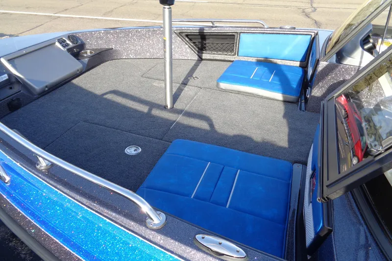 Slide: The Image of 2026 Ranger 1880MS Angler boat interior with blue seating and spacious deck. - 12