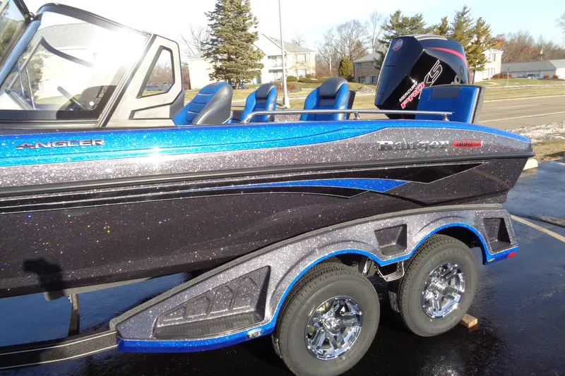 Slide: The Image of 2026 Ranger 1880MS Angler boat with sparkling blue and black finish on a trailer. - 16