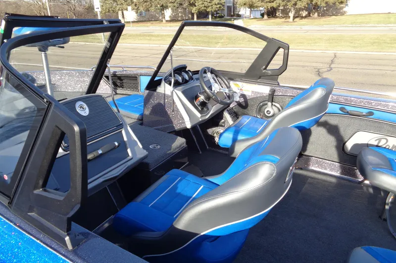 Slide: The Image of 2026 Ranger 1880MS Angler boat interior with blue and gray seating, steering console, and dashboard. - 18