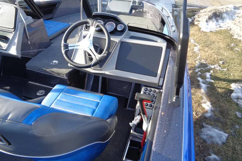 Slide: The Image of 2026 Ranger 1880MS Angler boat interior with blue seating and modern dashboard. - 9