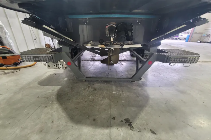 Slide: The Image of Rear view of a 2022 MasterCraft X22 boat on a trailer in a garage. - 14