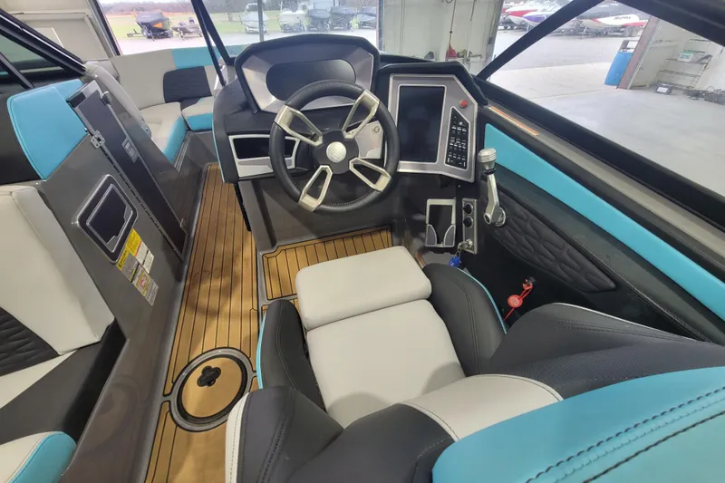 Slide: The Image of 2022 MasterCraft X22 boat interior with modern dashboard and steering wheel. - 17