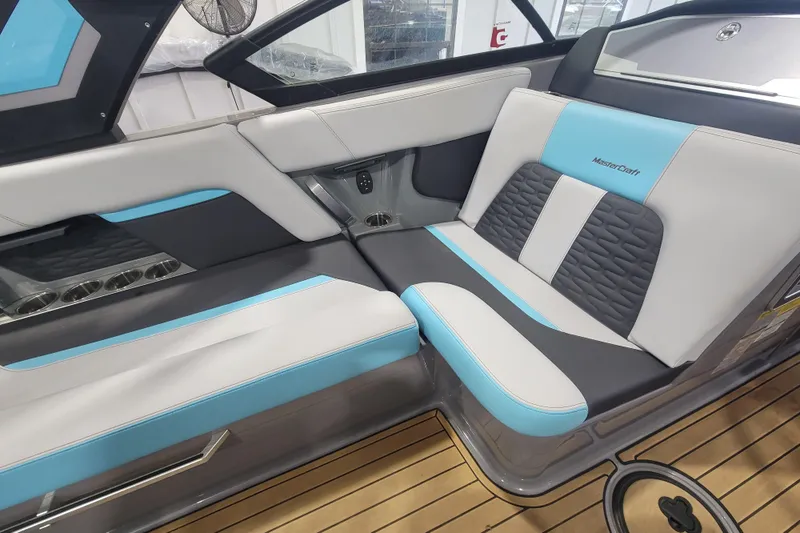 Slide: The Image of 2022 MasterCraft X22 boat interior with stylish blue and gray seating. - 18