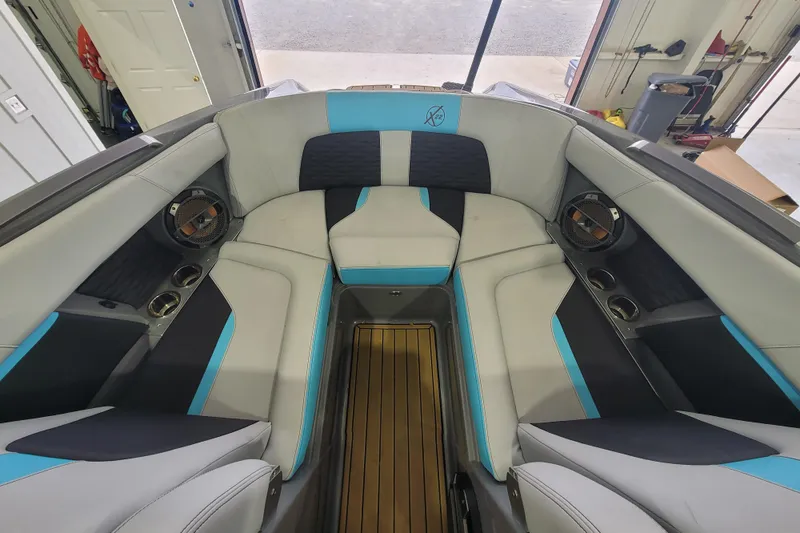 Slide: The Image of Interior of a 2022 MasterCraft X22 boat with stylish seating and speakers. - 20