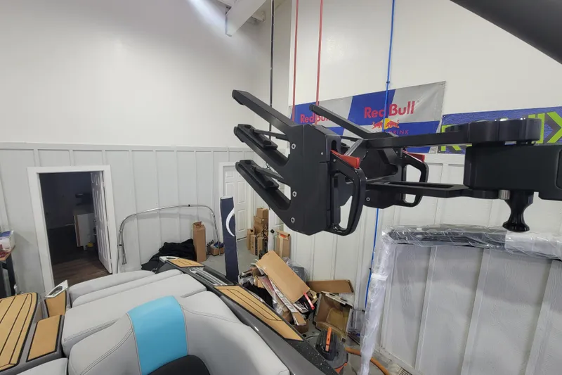 Slide: The Image of 2022 MasterCraft X22 boat interior with wakeboard rack in a garage setting. - 21