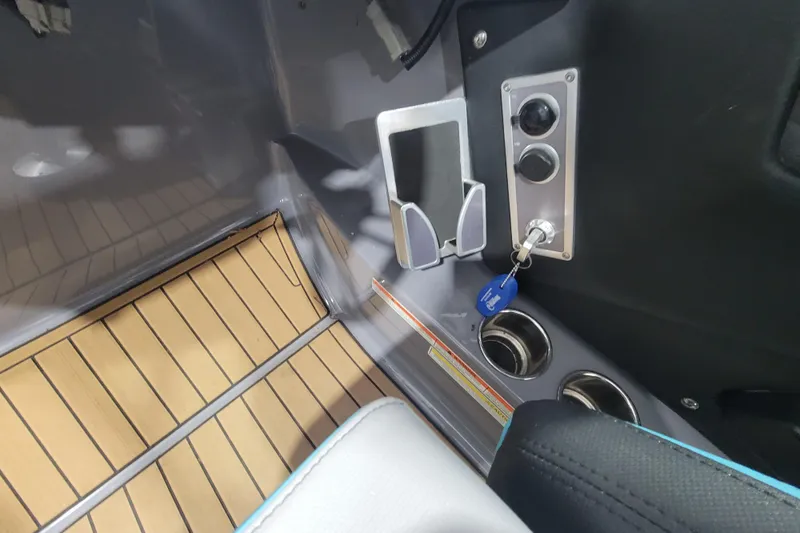 Slide: The Image of Interior of 2022 MasterCraft X22 boat with key ignition and phone holder. - 23