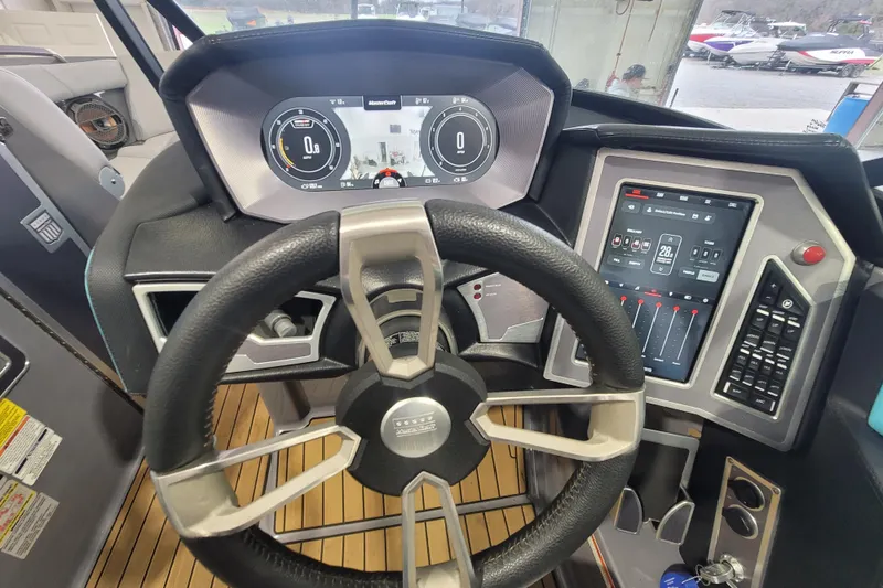 Slide: The Image of 2022 MasterCraft X22 boat dashboard with steering wheel and digital controls. - 25