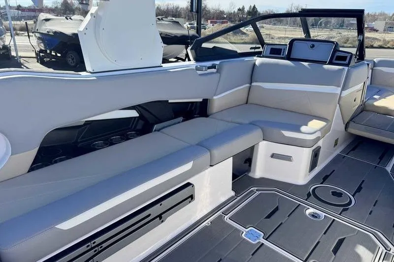 Slide: The Image of 2022 Supra SL boat interior with sleek seating and modern design. - 12