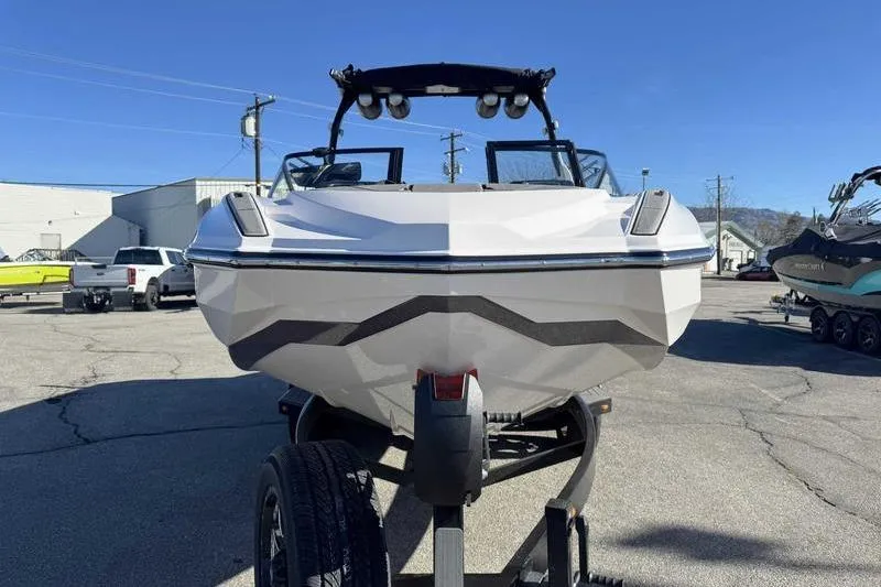 Slide: The Image of 2022 Supra SL boat on trailer in parking lot, front view. - 5