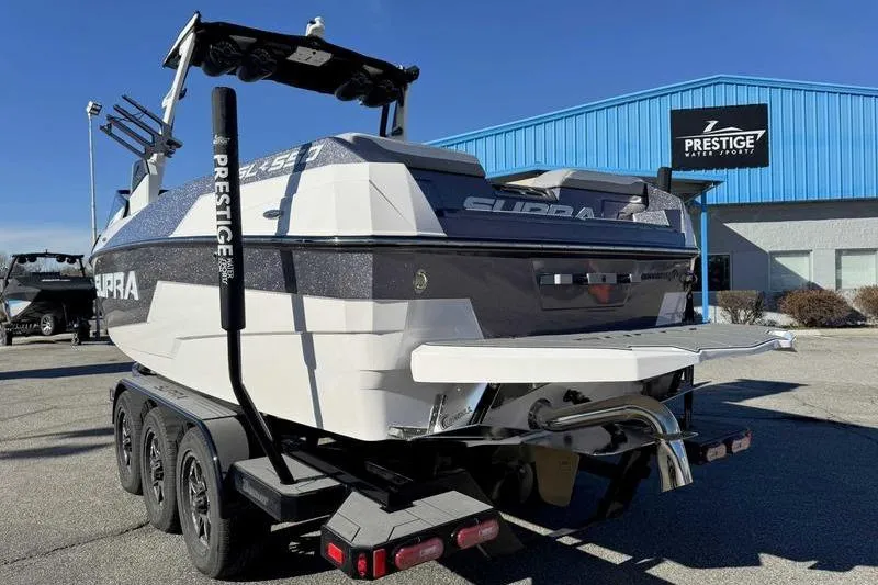 Slide: The Image of 2022 Supra SL boat on trailer at Prestige Water Sports dealership. - 9