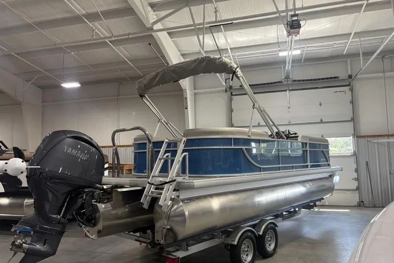 Slide: The Image of 2025 Godfrey Xperience 2286 SBX pontoon boat in a garage with Yamaha outboard motor. - 14