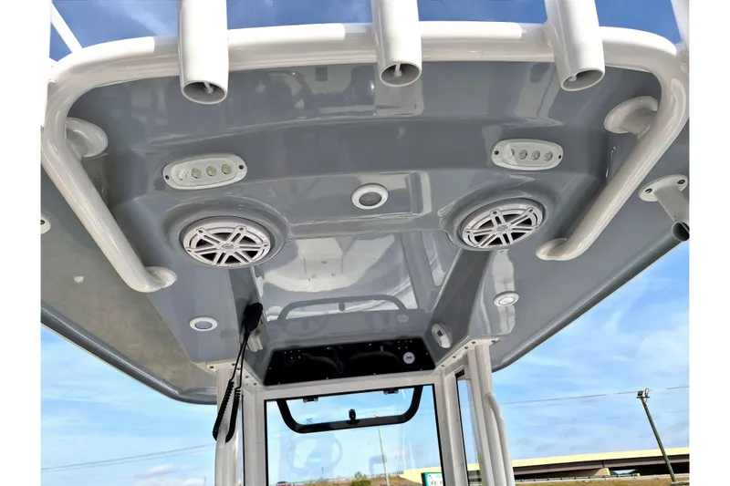 Slide: The Image of 2026 Sportsman Heritage 231 Center Console T-top with speakers and rod holders. - 12