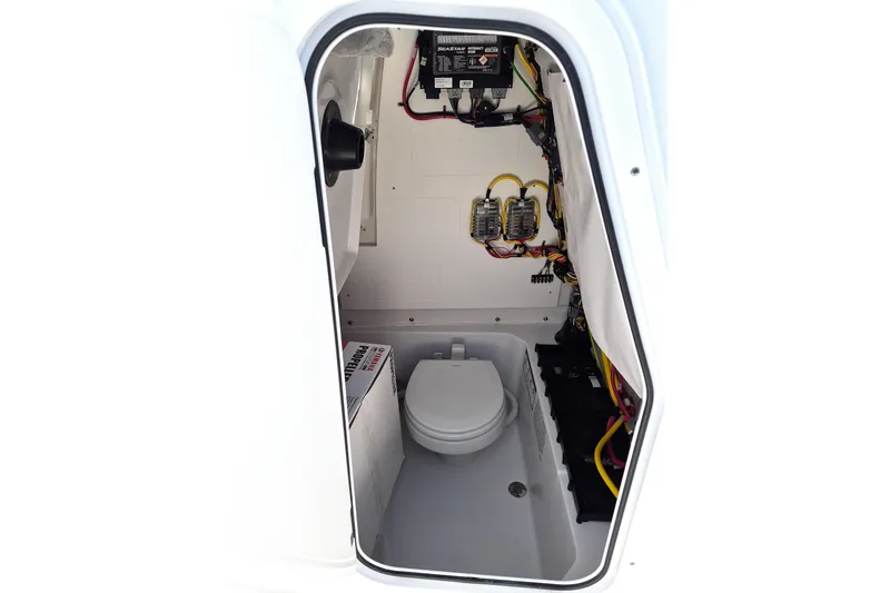 Slide: The Image of 2026 Sportsman Heritage 231 Center Console interior with marine toilet and electrical components. - 14