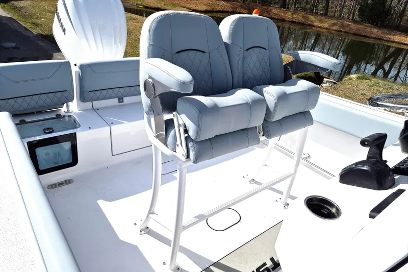 Slide: The Image of 2026 Sportsman Heritage 231 Center Console boat with dual cushioned seats and sleek design. - 16