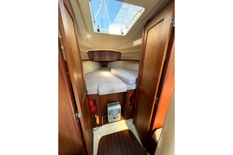 Slide: The Image of Interior of 1989 Hunter 30 sailboat with cozy seating and wooden accents. - 11