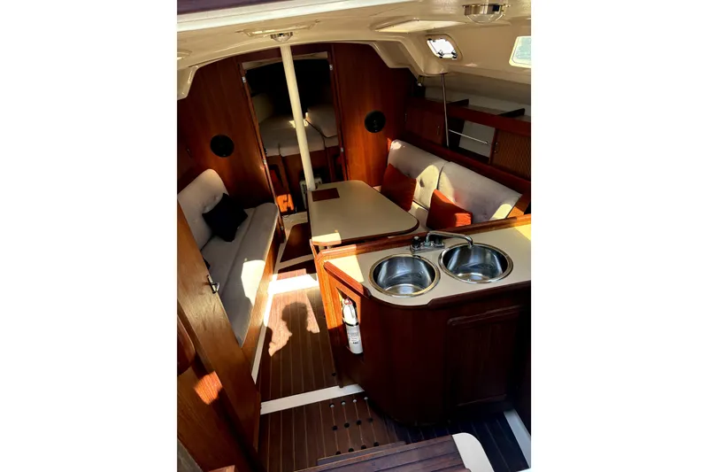 Slide: The Image of Interior of 1989 Hunter 30 sailboat with cozy cabin and wooden finish. - 13