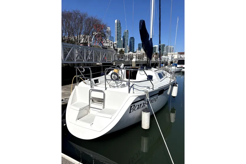 Slide: The Image of 1989 Hunter 30 sailboat docked in a marina, surrounded by other boats. - 2