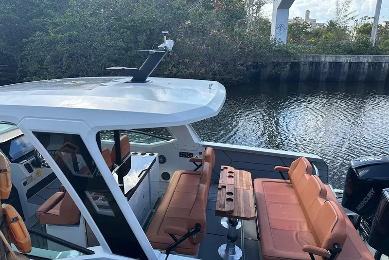 Slide: The Image of 2023 Saxdor 320 GTO boat with sleek design and comfortable seating on a calm waterway. - 18